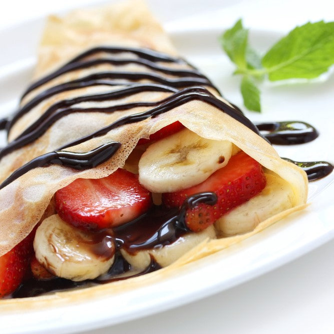Crepe pancake filed with Sweet Freedom Chocolate Syrup, bananas and strawberries. Perfect for Pancake Day